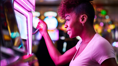 woman pulling slot machine lever
